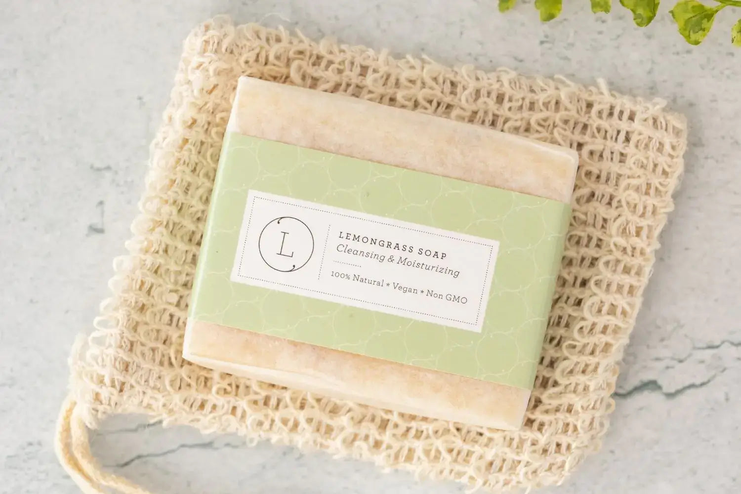 Handmade natural lemongrass soap bar on a jute soap bag, vegan and chemical-free, perfect for nourishing skin.