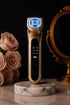 Premium 5-in-1 LED Skin Rejuvenation device on a marble stand with rose flowers in the background.