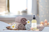 Massage drops eucalyptus oil with soft towels and floral accents, perfect for relaxation and rejuvenation.