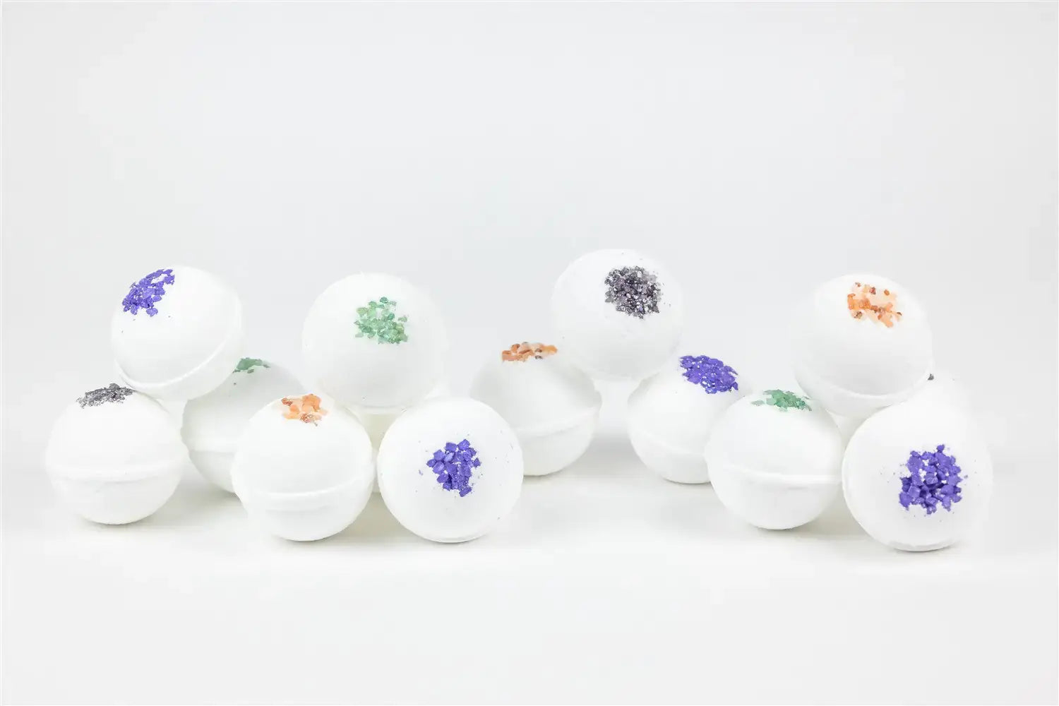 Lavender bath bombs with colorful flower accents arranged artistically for a calming self-care experience.