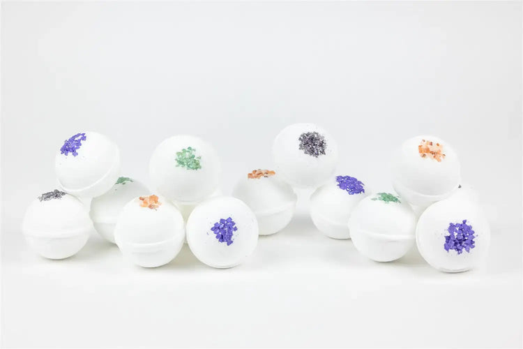 Lavender bath bombs with colorful flower accents arranged artistically for a calming self-care experience.