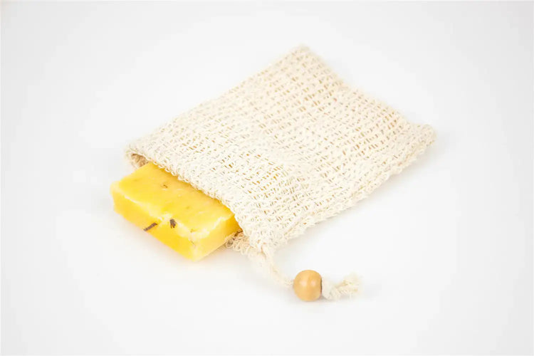 Natural lemongrass soap bar resting in a handmade mesh bag, ideal for eco-friendly skincare.