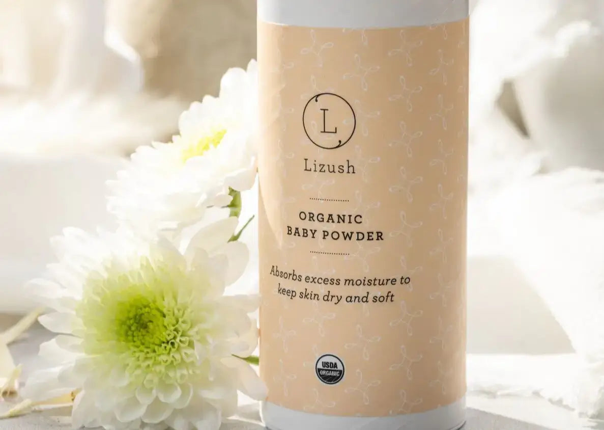 Organic baby powder by Lizush, designed to absorb moisture and keep baby skin dry and soft, featuring floral accents.
