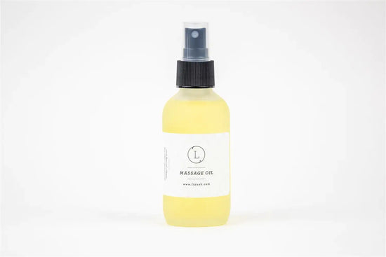 Massage oil in a spray bottle, featuring a simple label and a yellow liquid for relaxation and skincare.
