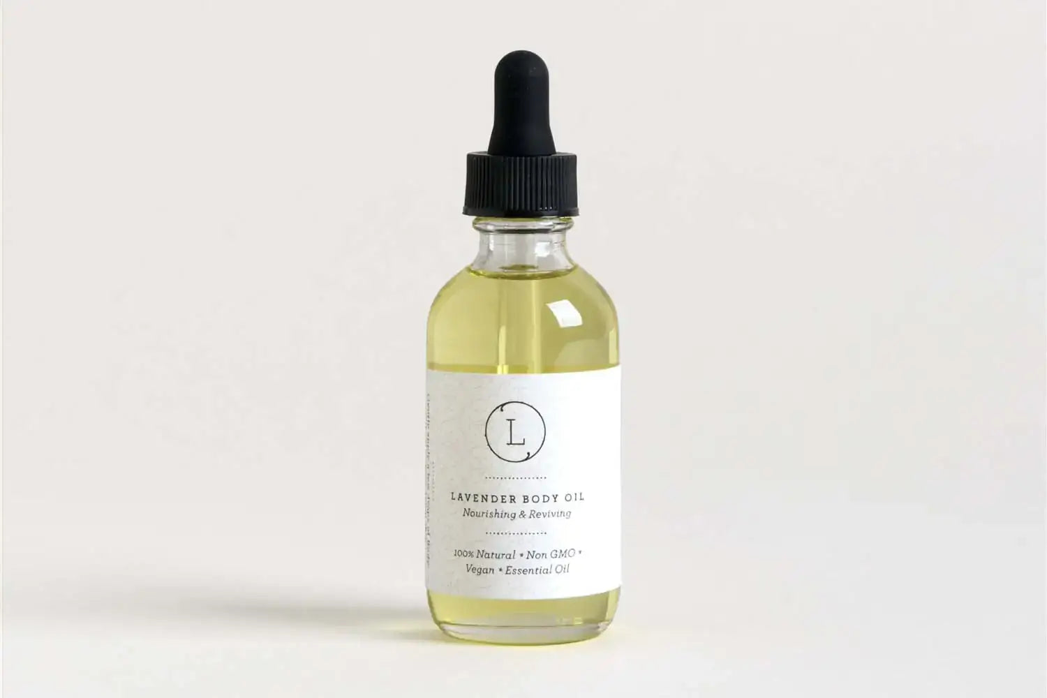 Bottle of lavender body oil for nourishing and calming self-care, with dropper and label.