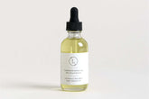 Bottle of lavender body oil for nourishing and calming self-care, with dropper and label.
