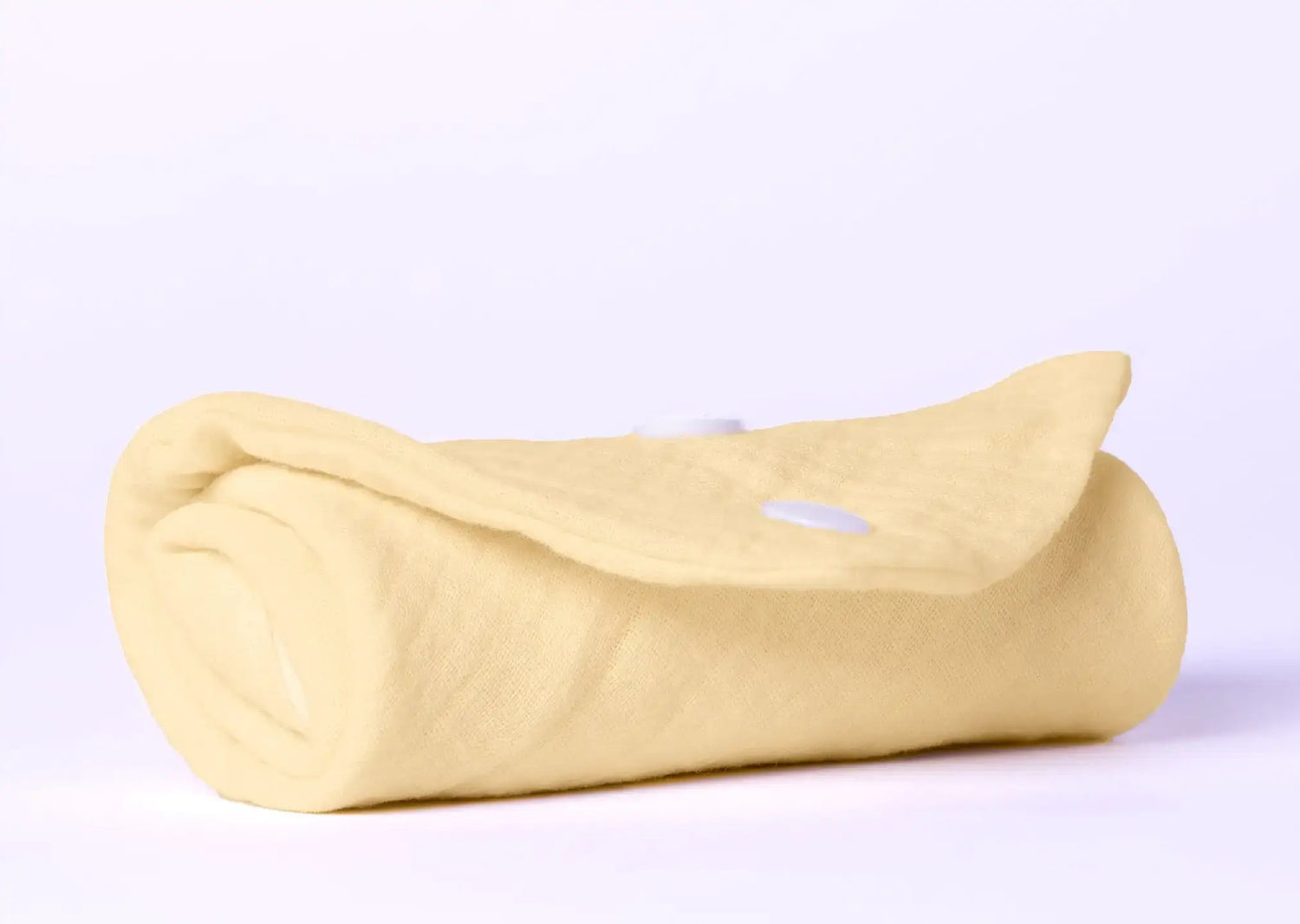 Rolled organic cotton baby blanket in soft yellow color, perfect for newborn care and comfort.