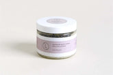 Lavender body scrub in a jar, promoting silky smooth skin and made with 100% natural ingredients.
